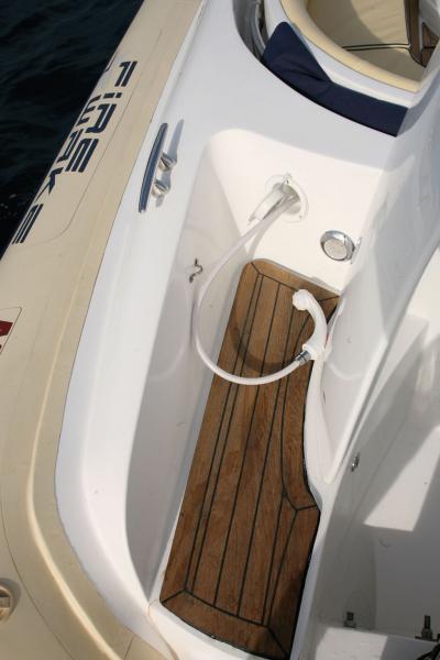 Le plat-bord délimité par l’hiloire de cockpit est garni de teck. La douchette est à portée de main. Notez la présence de l’éclairage par leds pour les mouillages nocturnes.
