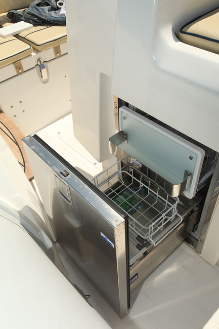 Le petit frigo à façade inox, intégré au leaning-post, coulisse sur des rails. 
