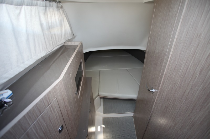 A l'entrée, la cabine est assez haute. A gauche, le meuble de rangement renferme la jauge carburant, le tableau électrique et la sono Fusion. A droite, le cabinet de toilette.